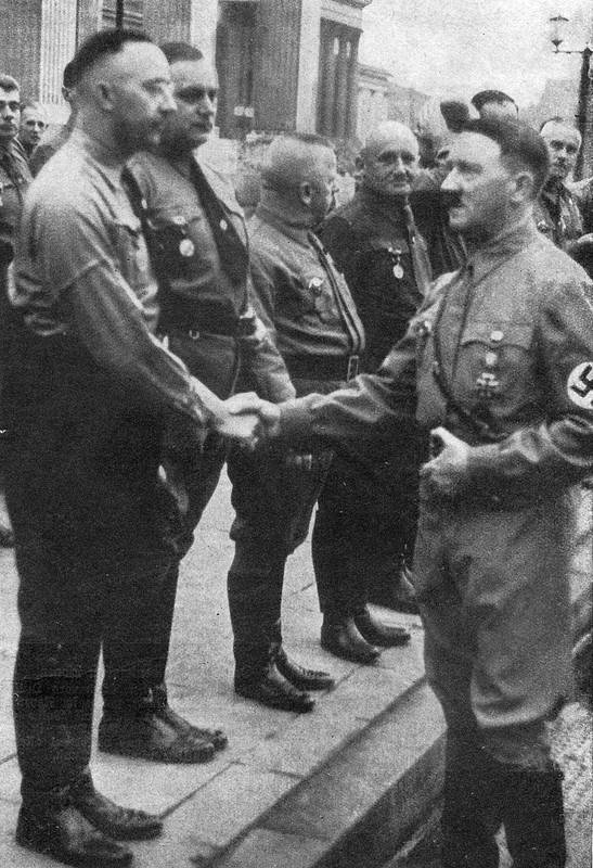 Adolf Hitler shakes hands with Heinrich Himmler during the 1938 Putsch commemoration in Munich
